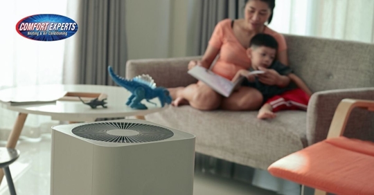 Woman reading book to child.