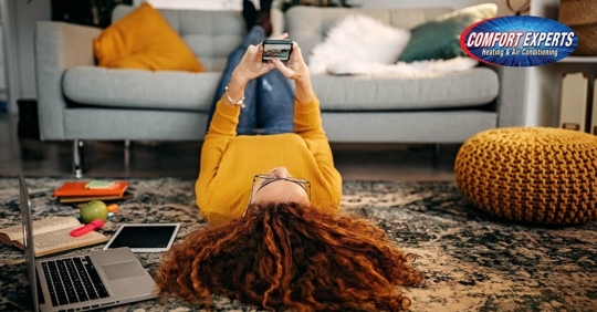 Woman laying on floor on the phone.