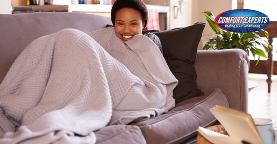 Woman sitting on couch.