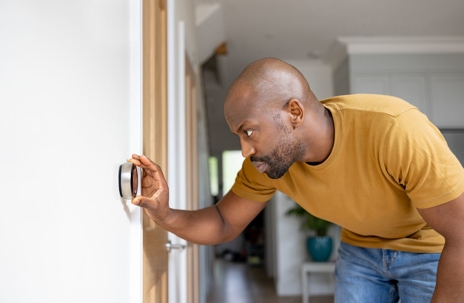 Man Adjusting Programmable Thermostat